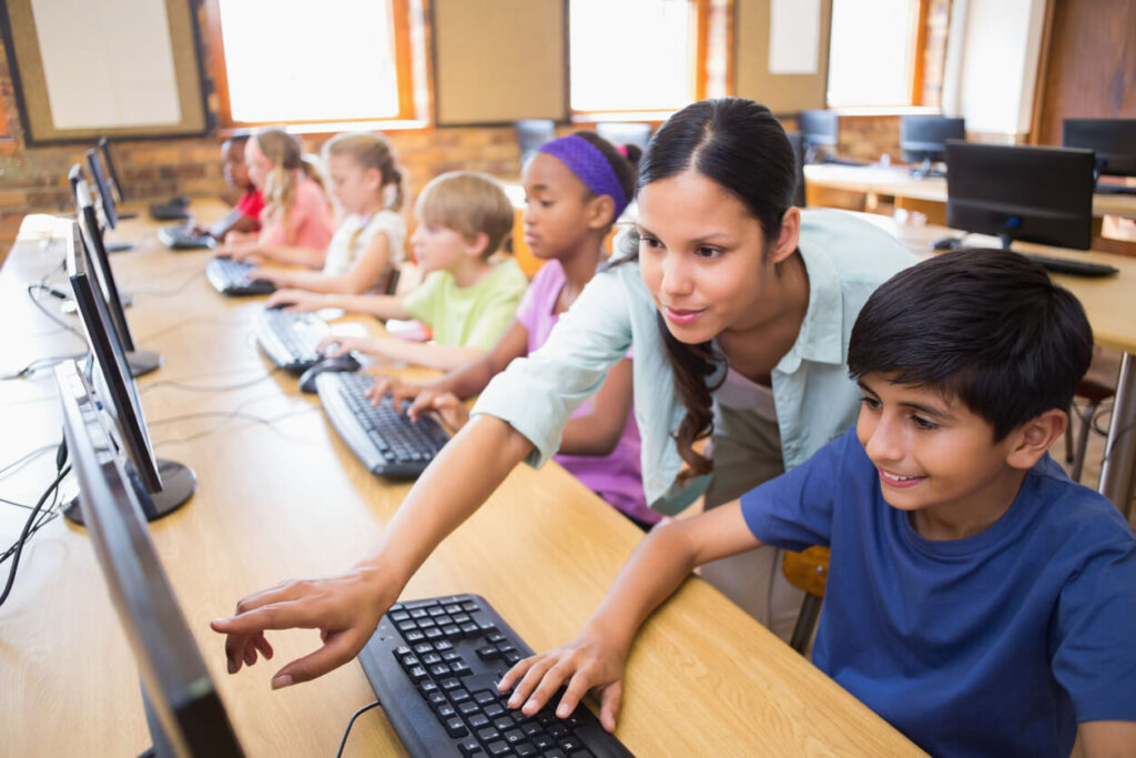 teacher teaching her student with technology