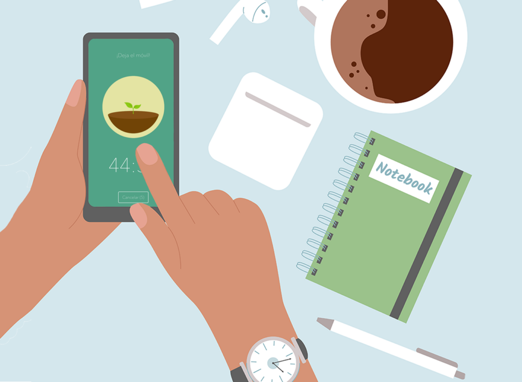 Person's hand uses a smartphone while notebook, earphones and coffee are lying aroung on a table.