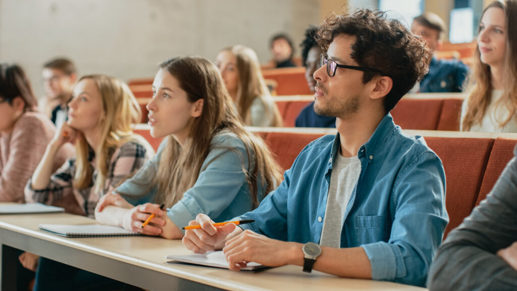Higher Education Policy Observatory students listening and writing in their notebooks
