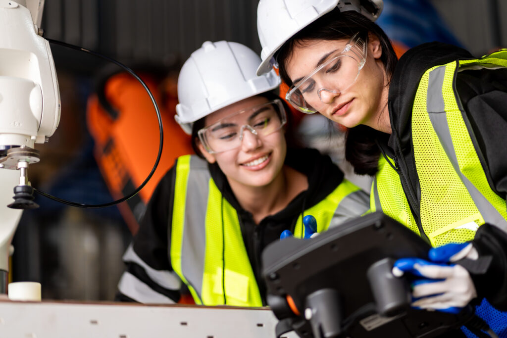 two engineers working on a machine