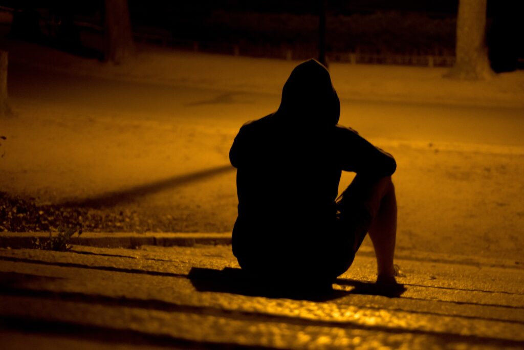 man silhouette sitting down