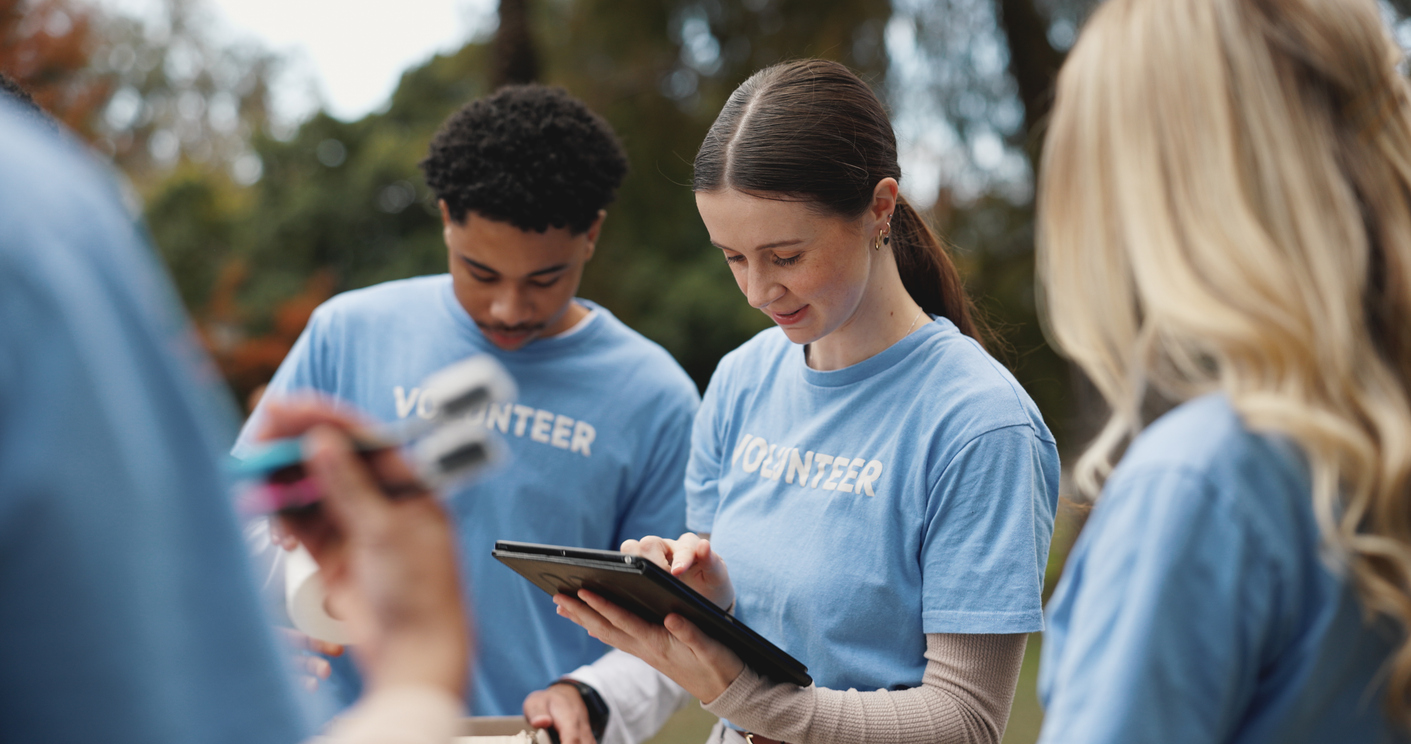 volunteer and people in park for charity event